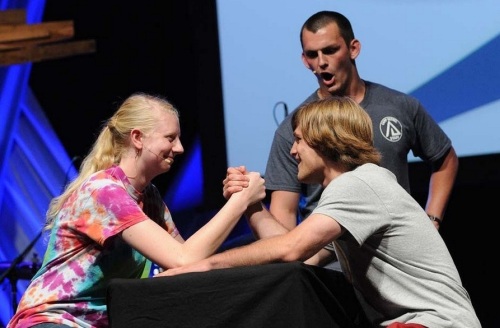 Shelley West arm-wrestles fellow Youth Peace Travel Team member Chris Bache at National Youth Conference . Photo by Glenn Riegel
